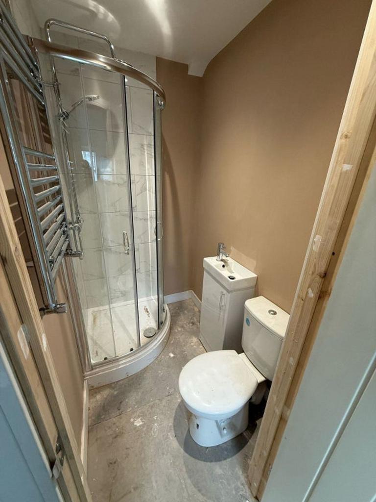 A modern bathroom featuring a sleek shower and ...