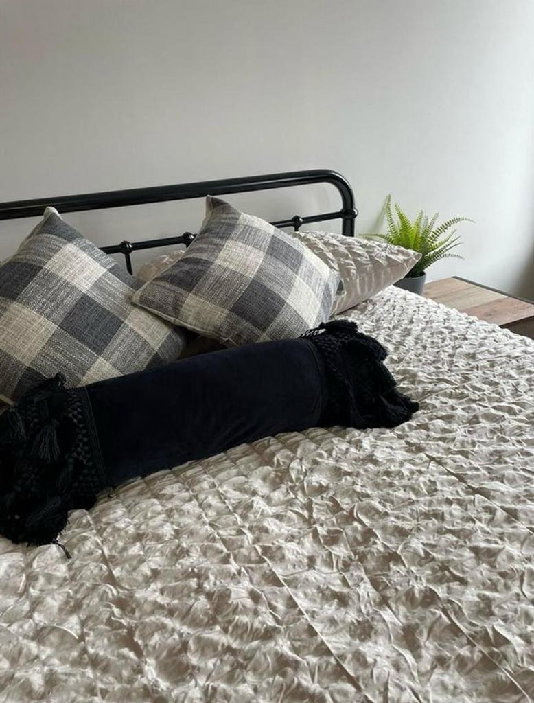 This stylish double bedroom features a cozy bed...