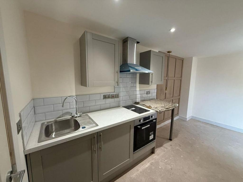 This modern kitchen features sleek cabinetry, a...