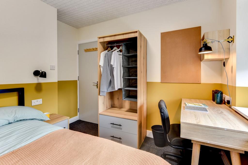 This stylish double bedroom features a cozy atm...