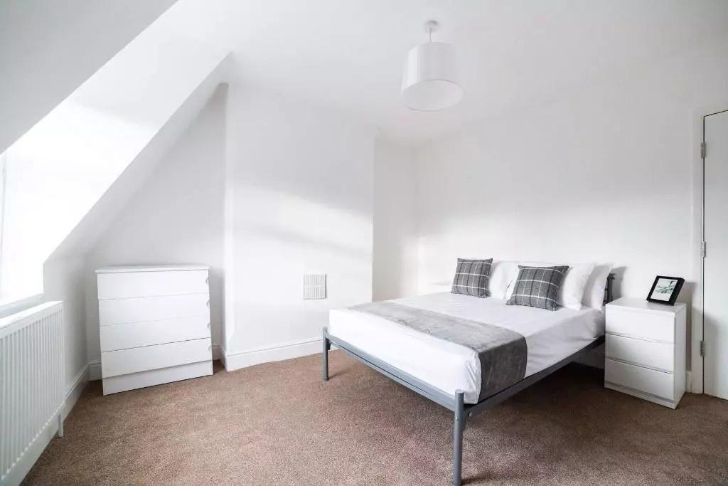 Bright and airy double bedroom featuring a comf...