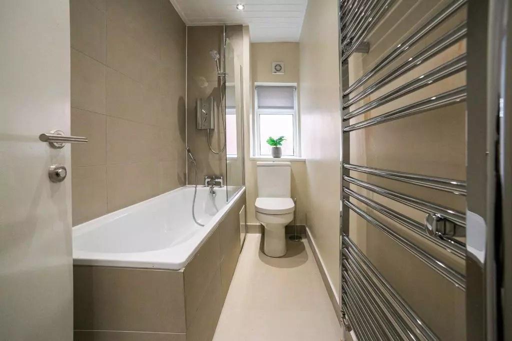 A modern bathroom suite featuring a spacious ba...