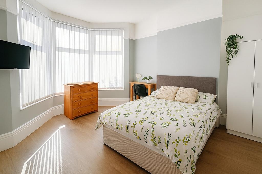 Bright and spacious master bedroom with a large...