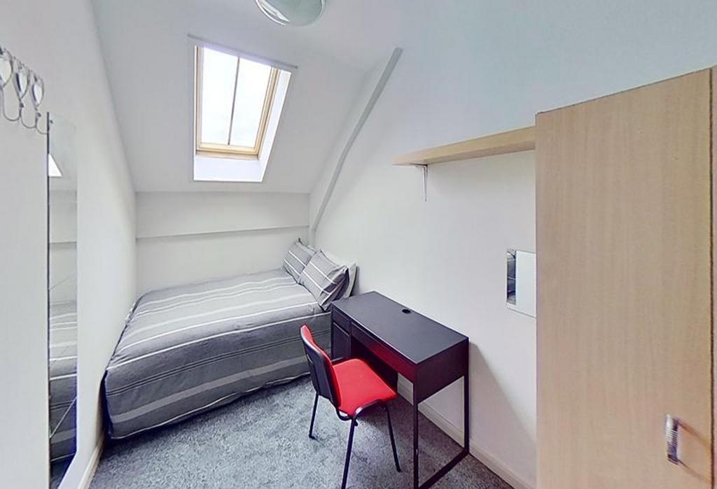 This charming double bedroom features a cozy be...