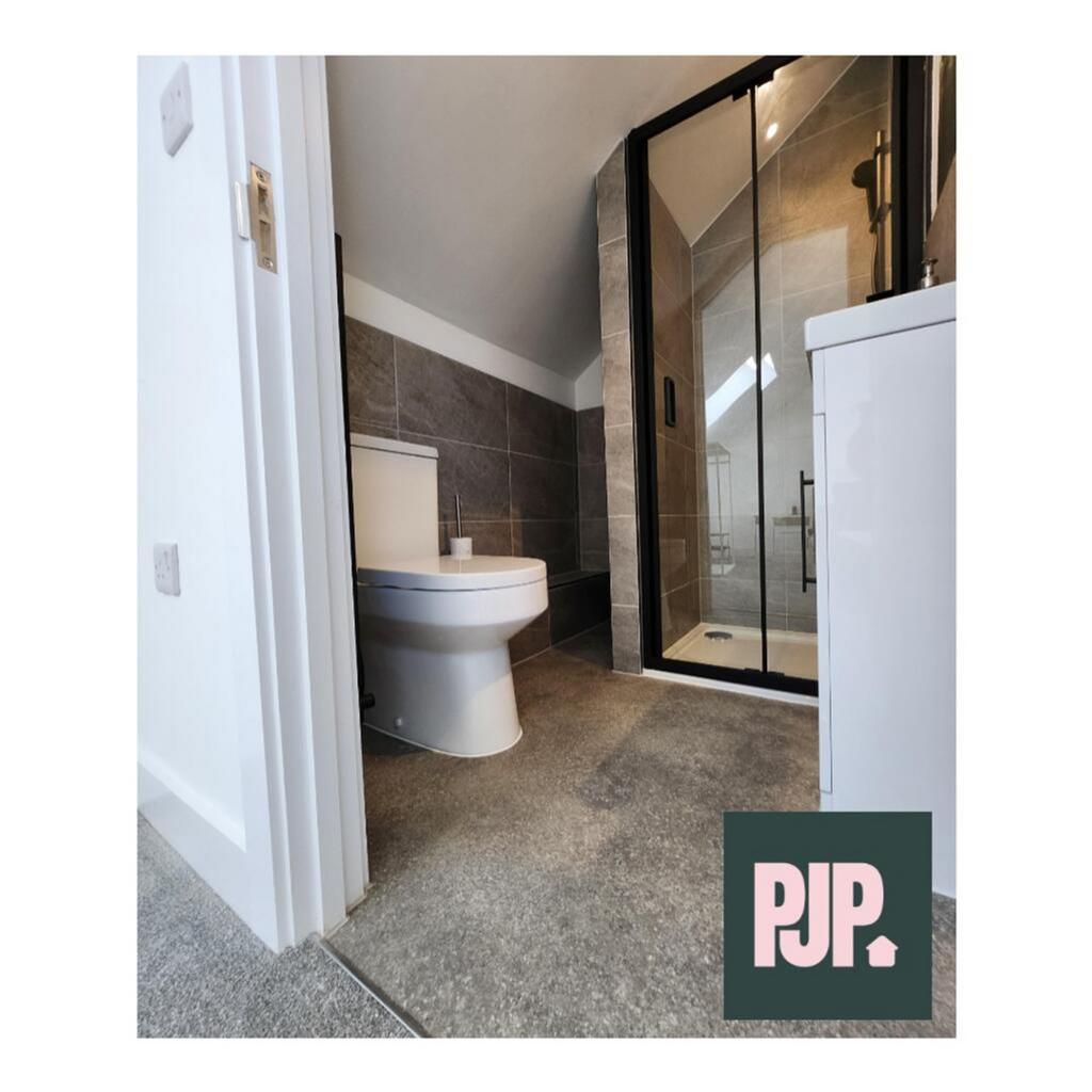 A modern bathroom featuring elegant tiles, a sp...