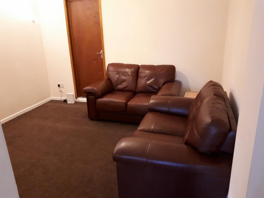 A cozy living room featuring comfortable leathe...