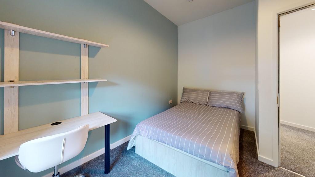 A stylish and well-lit double bedroom featuring...