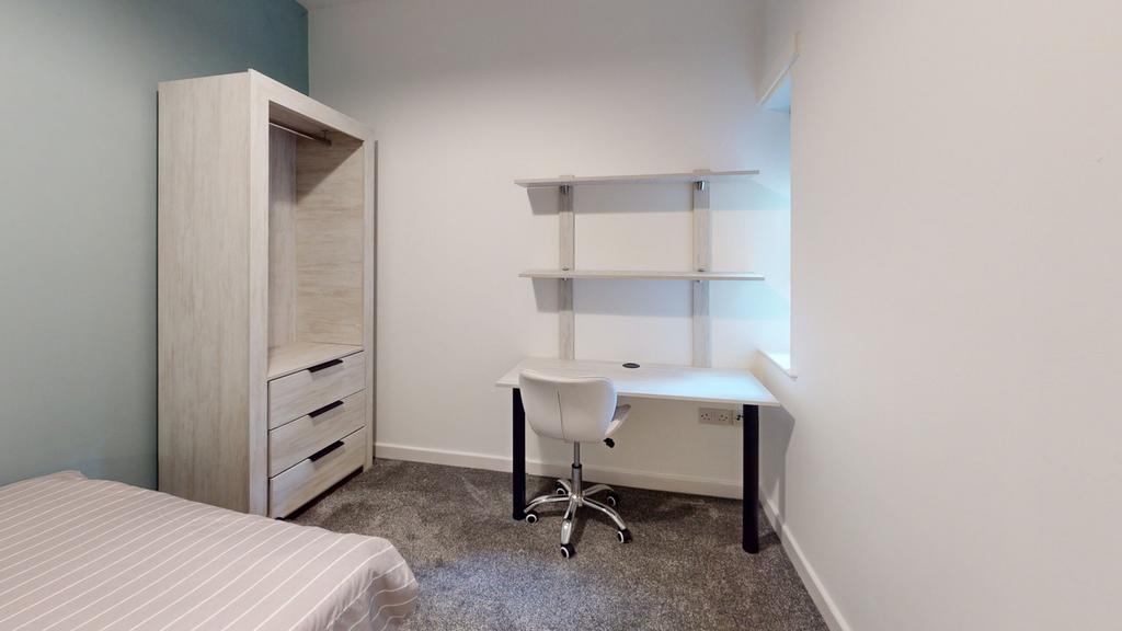 A tidy and well-lit double bedroom featuring mo...