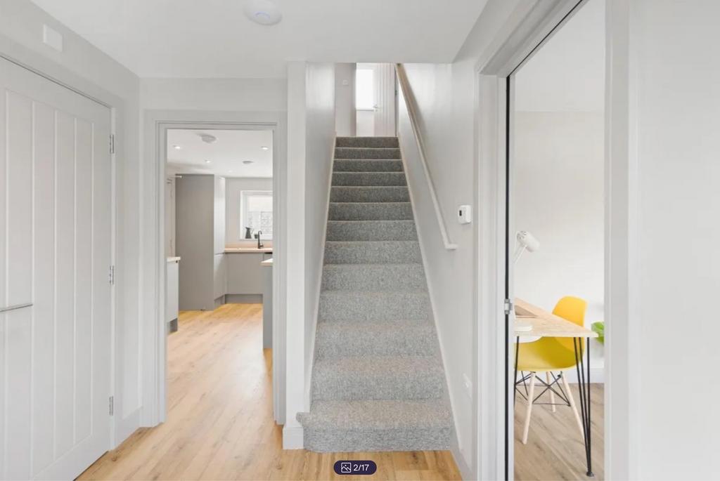 A bright and clean hallway leading to various r...