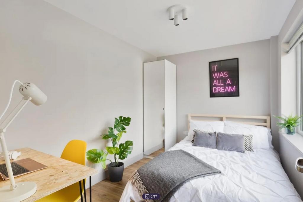 A bright and inviting double bedroom featuring ...