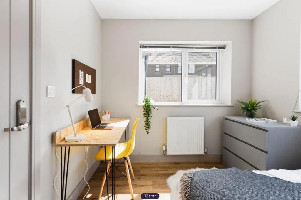 A bright and clean double bedroom featuring a w...