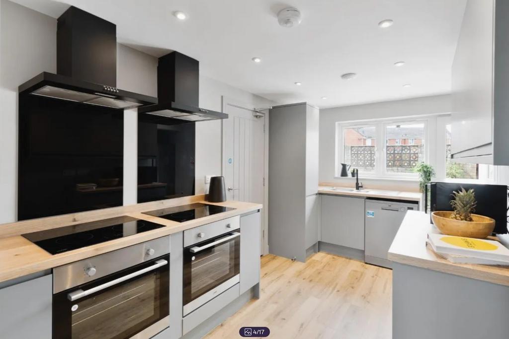 A modern and bright kitchen featuring sleek app...