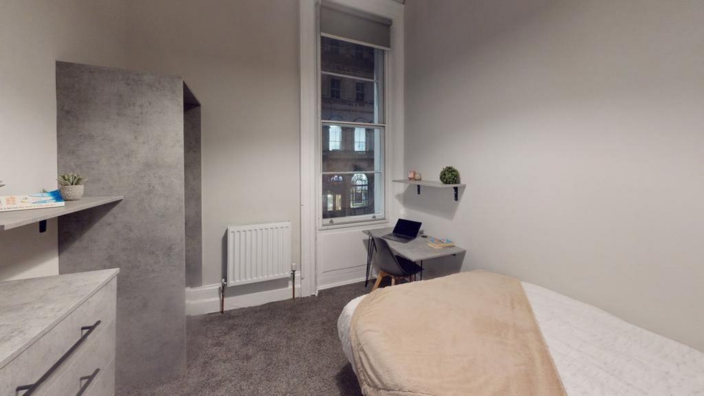 A modern and inviting double bedroom with ample...