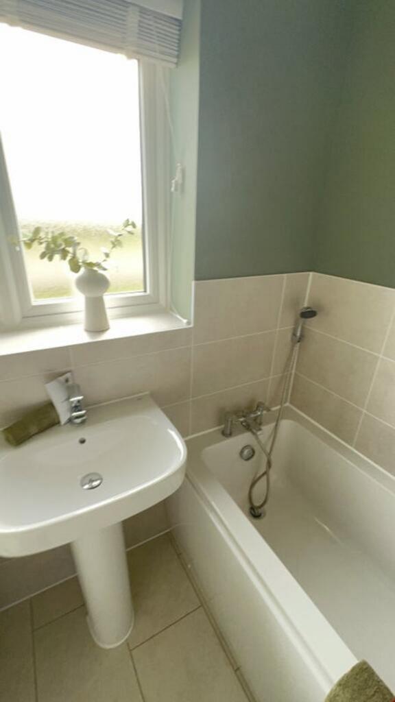 Bright and modern bathroom featuring a sleek si...