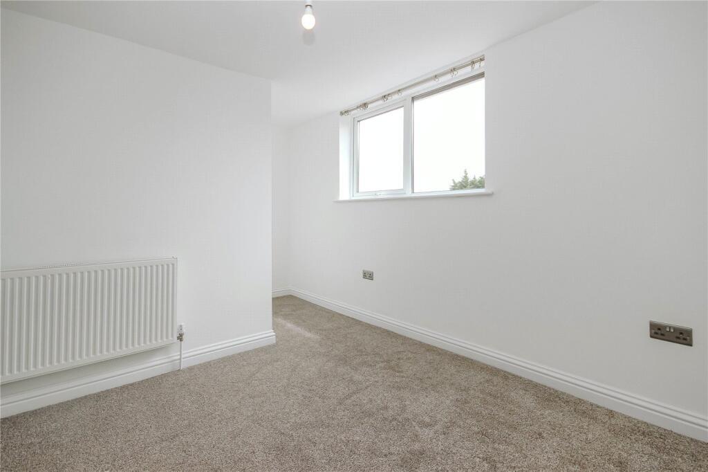 Bright and clean single bedroom featuring neutr...