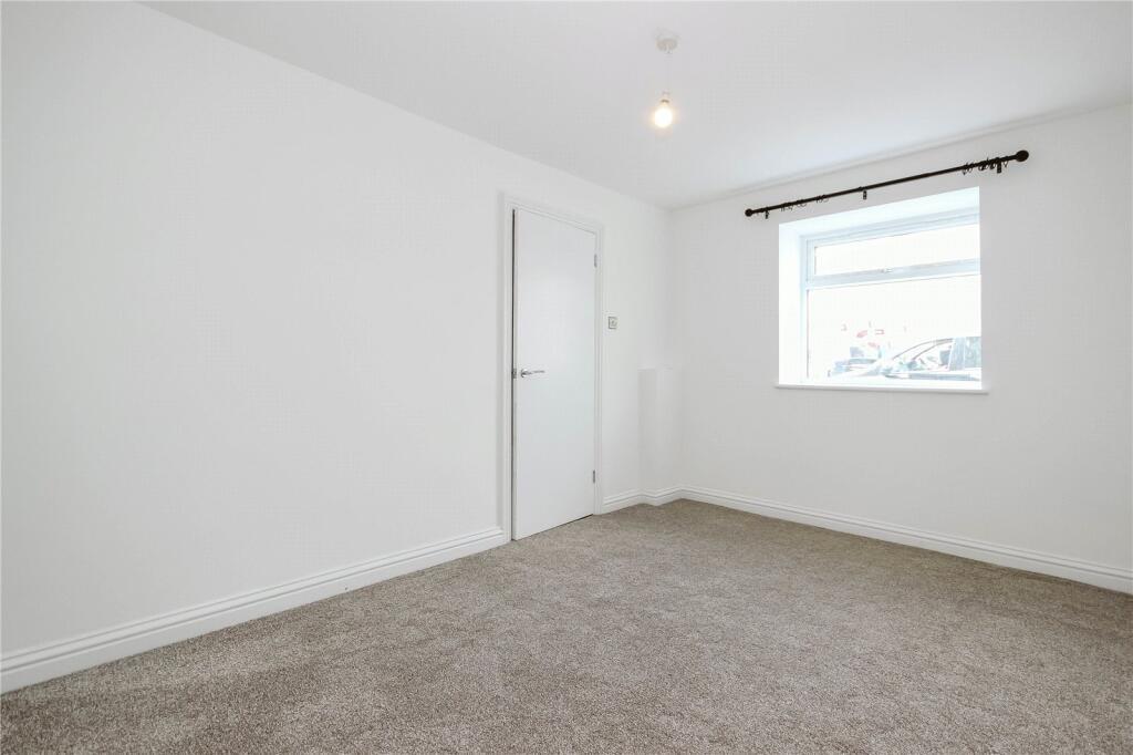 Bright and clean double bedroom featuring neutr...