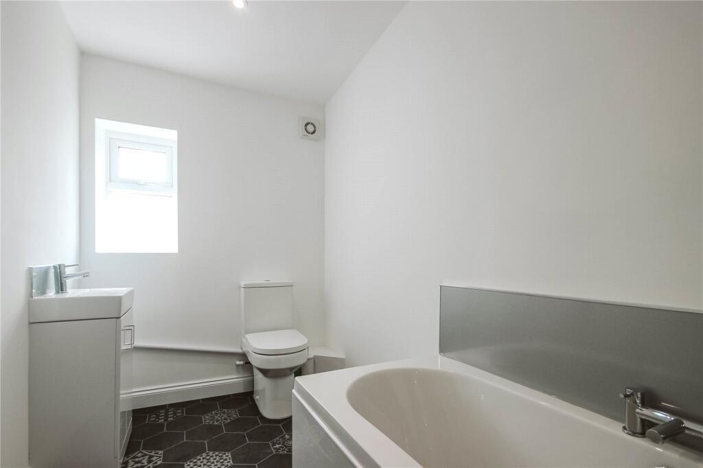Bright and clean bathroom featuring a modern ba...
