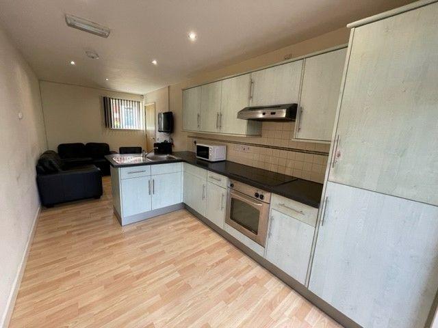A modern kitchen featuring light wood cabinetry...
