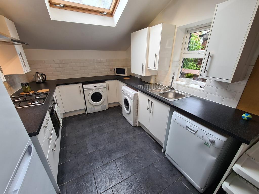 A bright and modern kitchen with ample storage ...