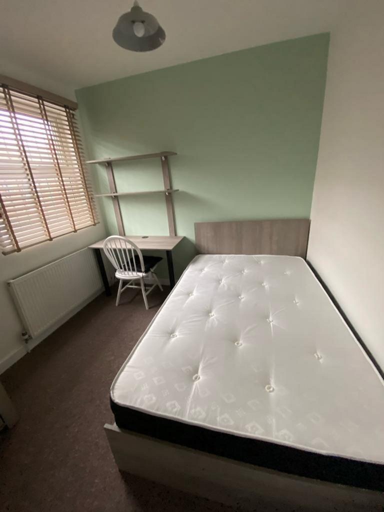 A cozy double bedroom with a comfortable bed an...