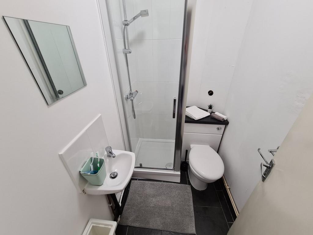 A modern and tidy bathroom featuring a spacious...