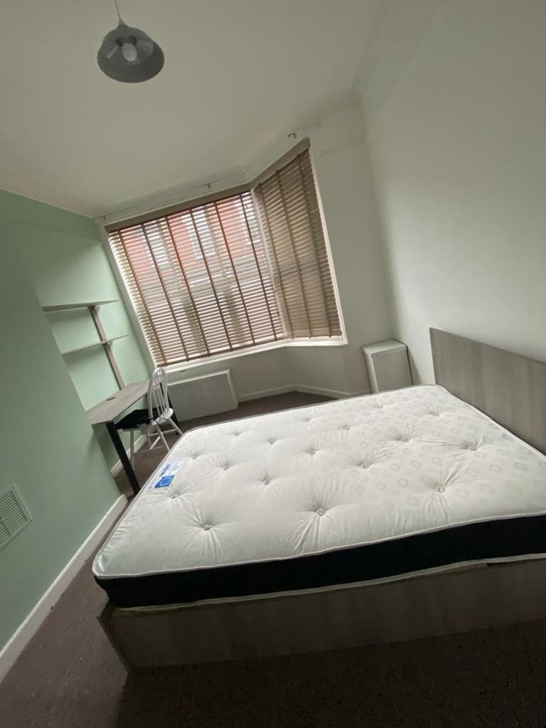 A spacious and well-lit double bedroom featurin...