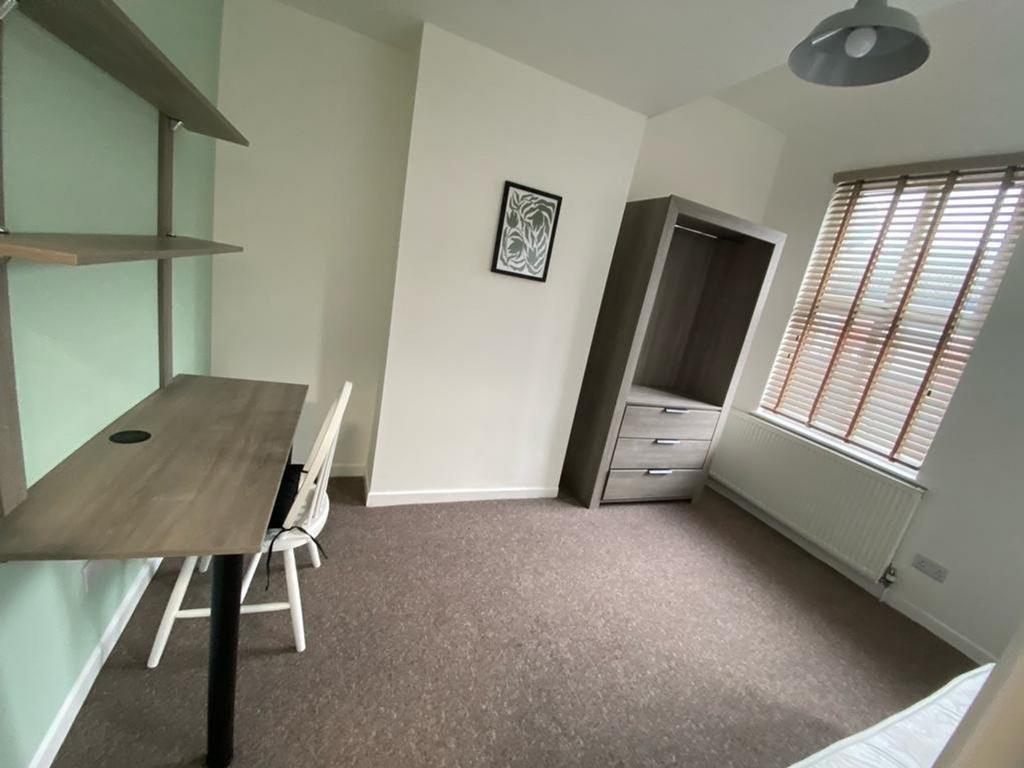 A bright and tidy double bedroom featuring a st...