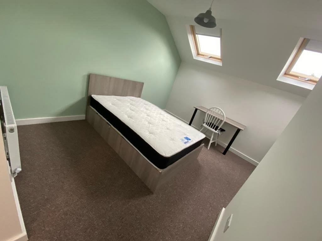 A spacious and inviting double bedroom featurin...