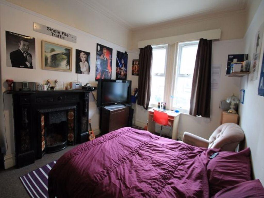 A cozy and inviting master bedroom featuring a ...