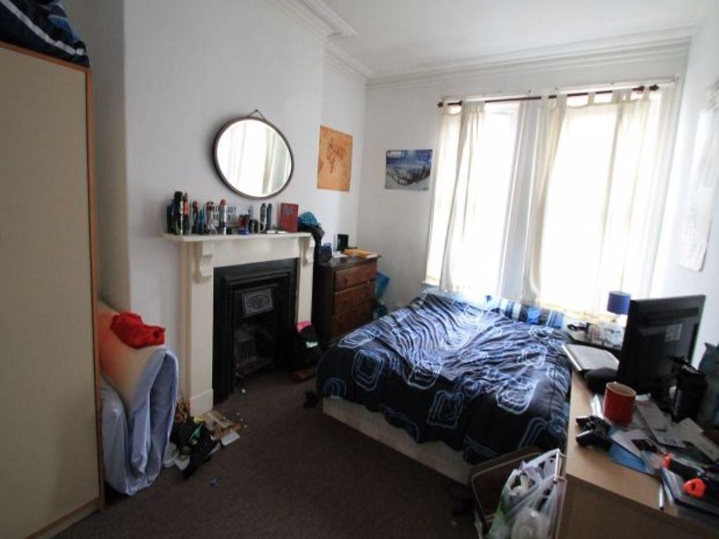 Bright double bedroom featuring a large window ...