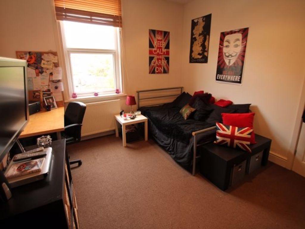 A cozy and well-maintained bedroom featuring a ...