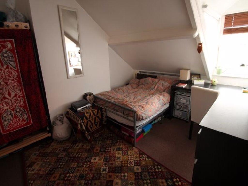 Cozy single bedroom with a skylight window offe...