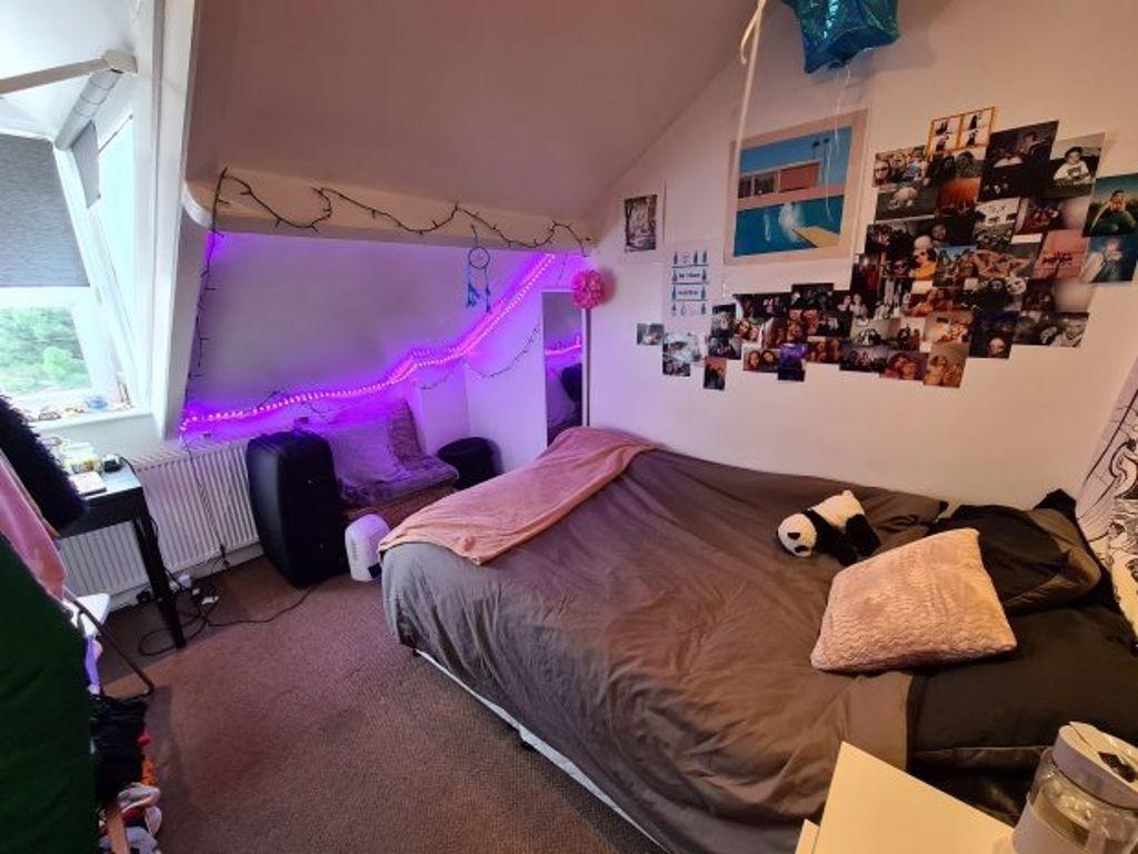 Cozy and personalized bedroom featuring a comfo...