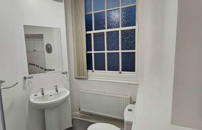 A clean and well-maintained bathroom with a whi...
