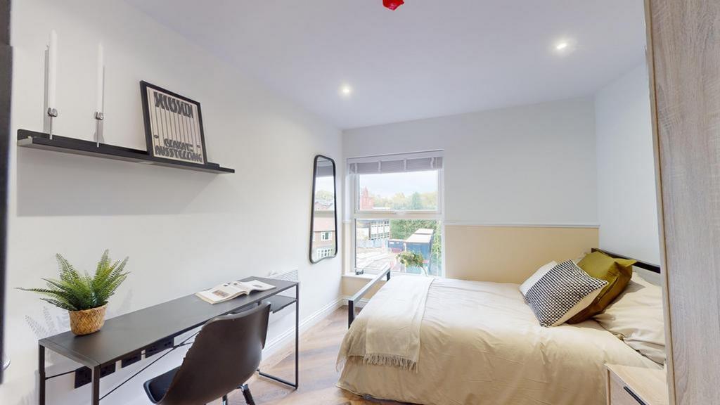 A bright and inviting double bedroom with moder...