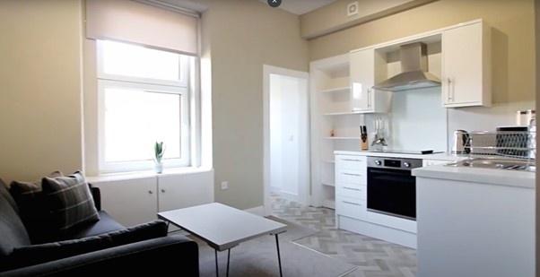 A bright and modern kitchen featuring white cab...