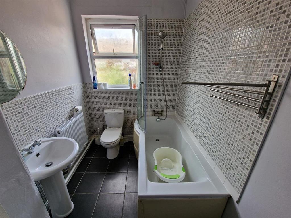 A clean and modern bathroom featuring a full ba...