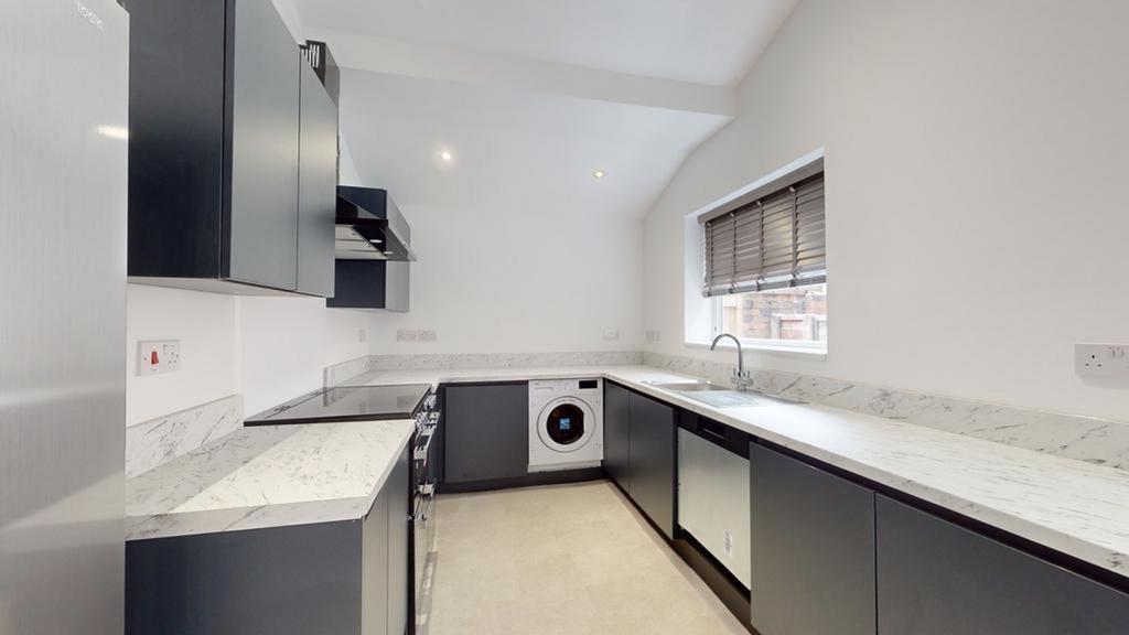 A modern and spacious kitchenette with sleek ca...