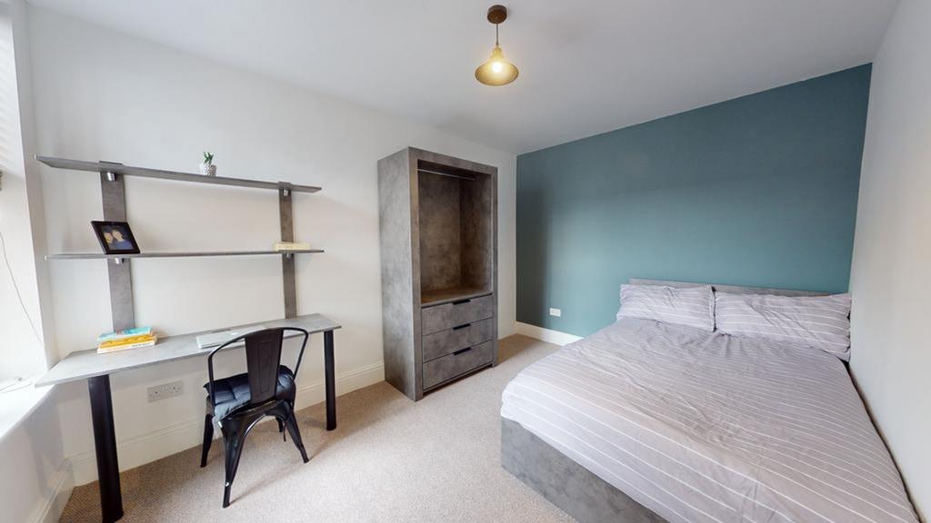 A bright and inviting double bedroom featuring ...