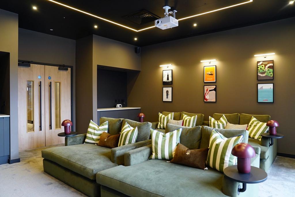 A stylish and modern cinema room featuring plus...