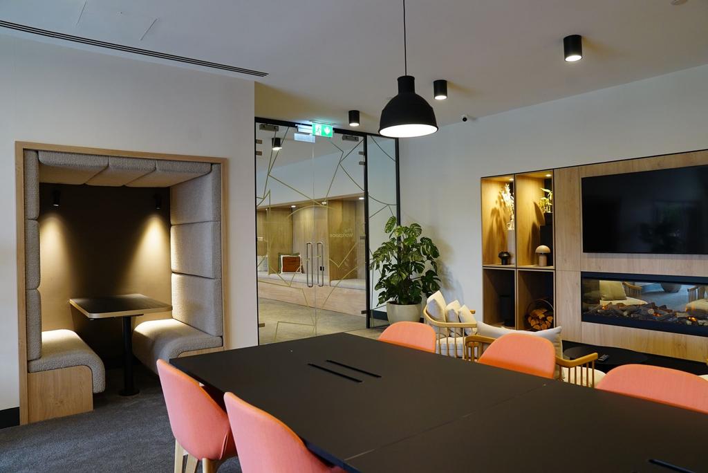 Modern communal workspace featuring a large bla...
