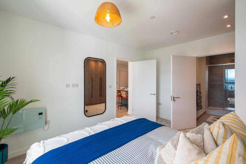 A bright and welcoming master bedroom featuring...