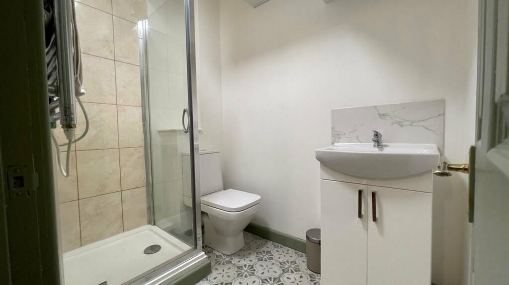 A modern and tidy bathroom featuring a sleek sh...