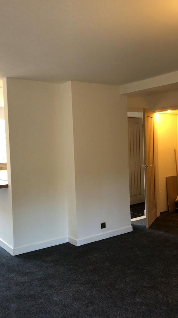 A bright and clean hallway featuring neutral wa...