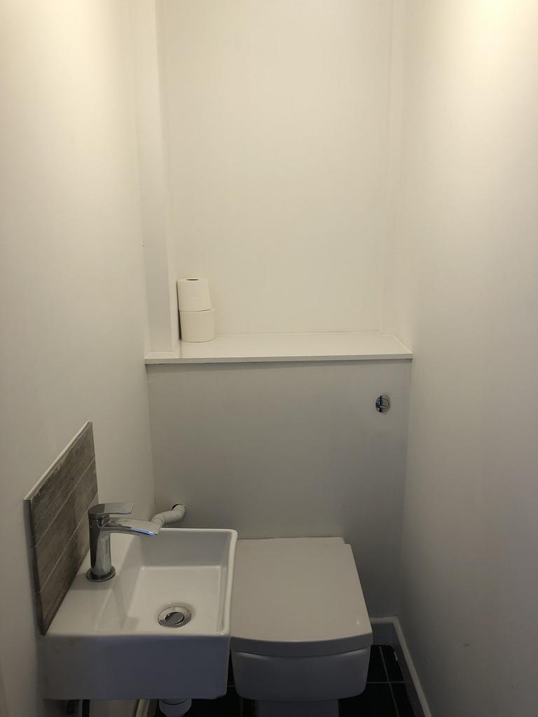 Compact and neat single toilet with a modern wh...