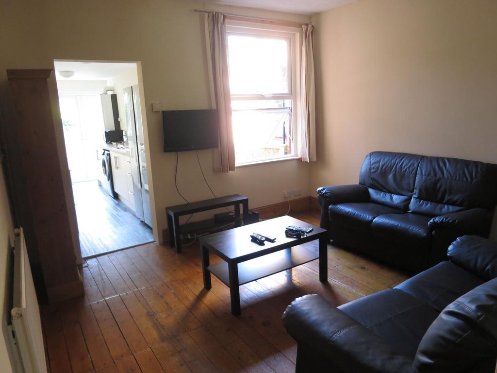 Cozy living room featuring comfortable dark lea...