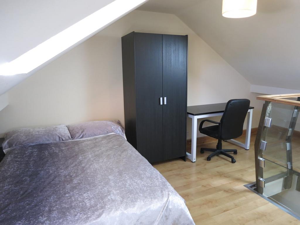 Bright and tidy double bedroom featuring a comf...