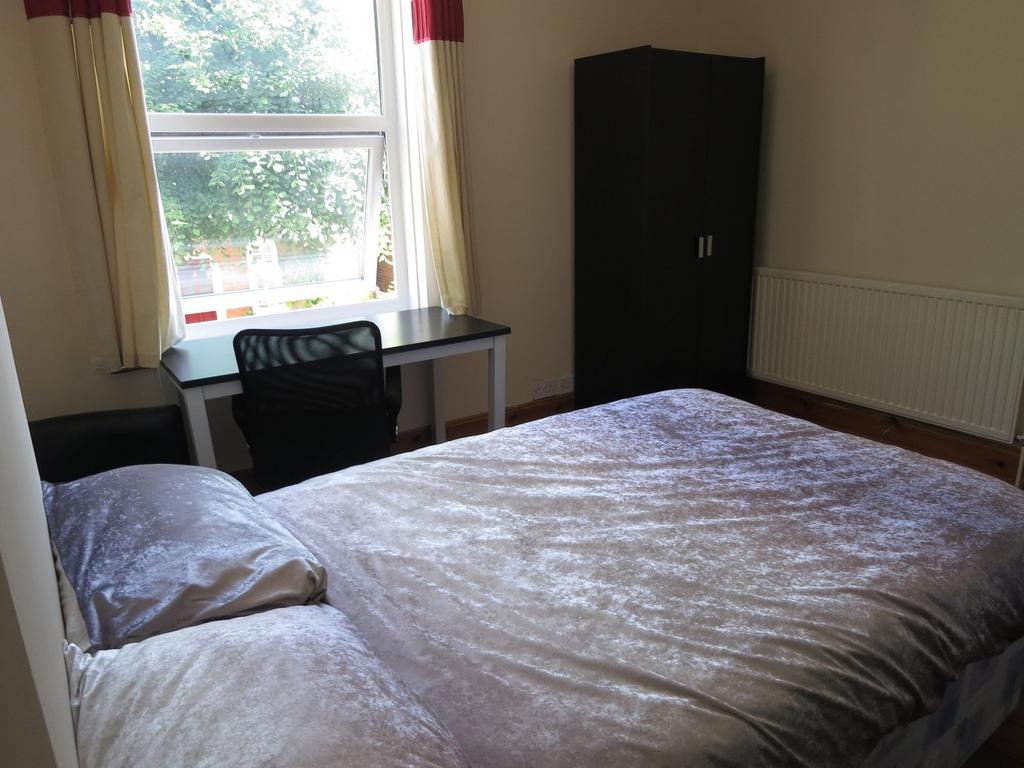 This bright double bedroom features a comfortab...