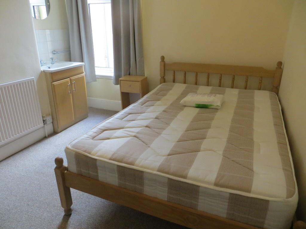 Bright double bedroom featuring a comfortable w...