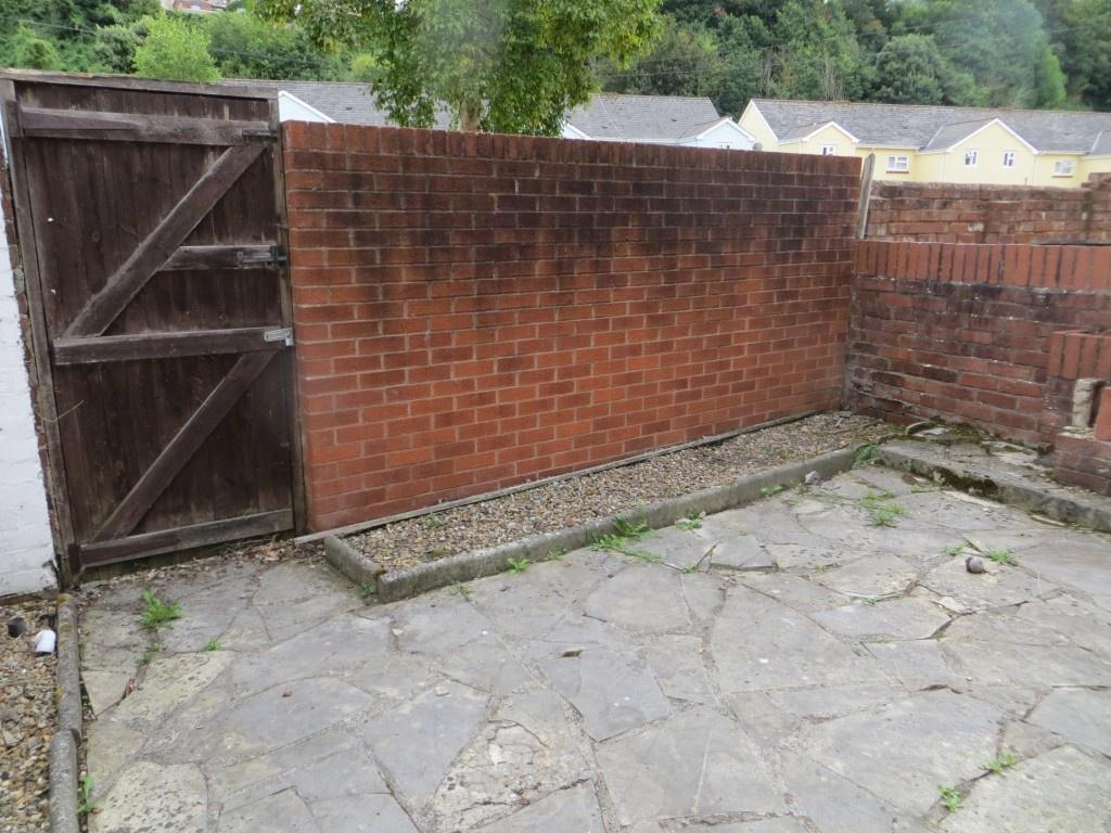 A private outdoor garden area with a stone pave...